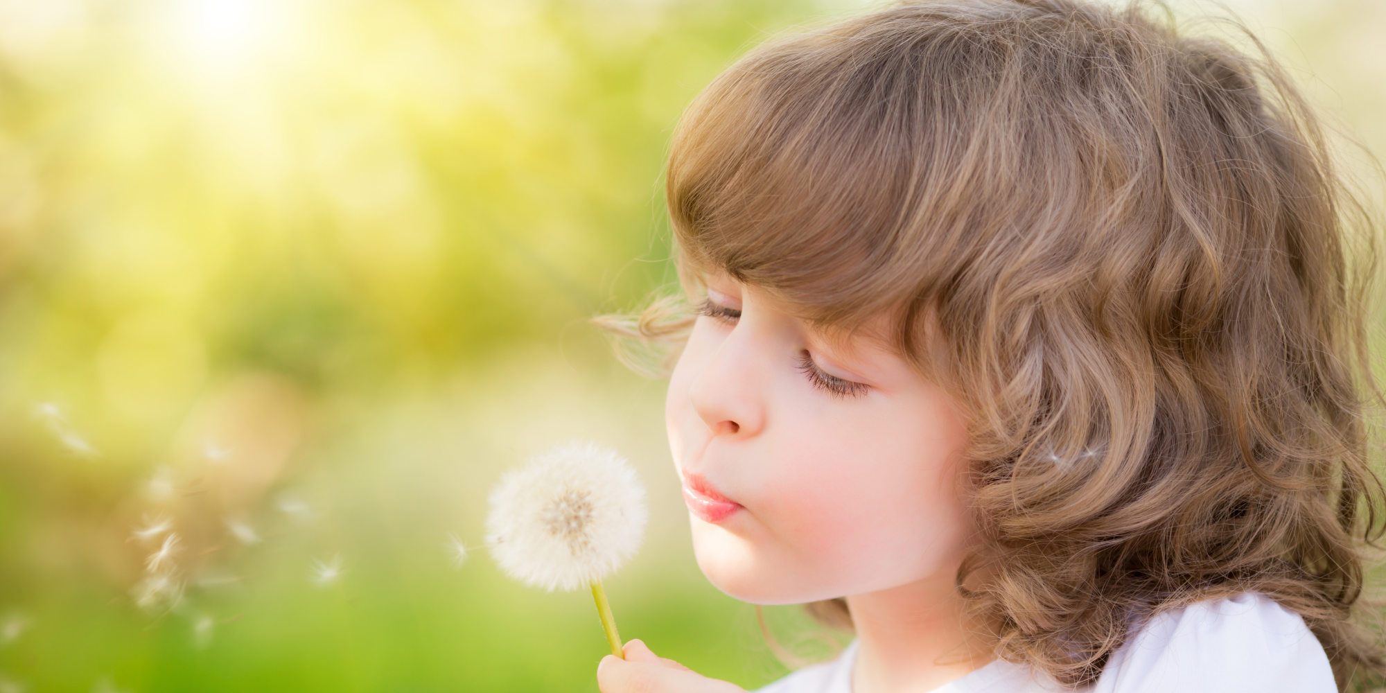 child with dandelion